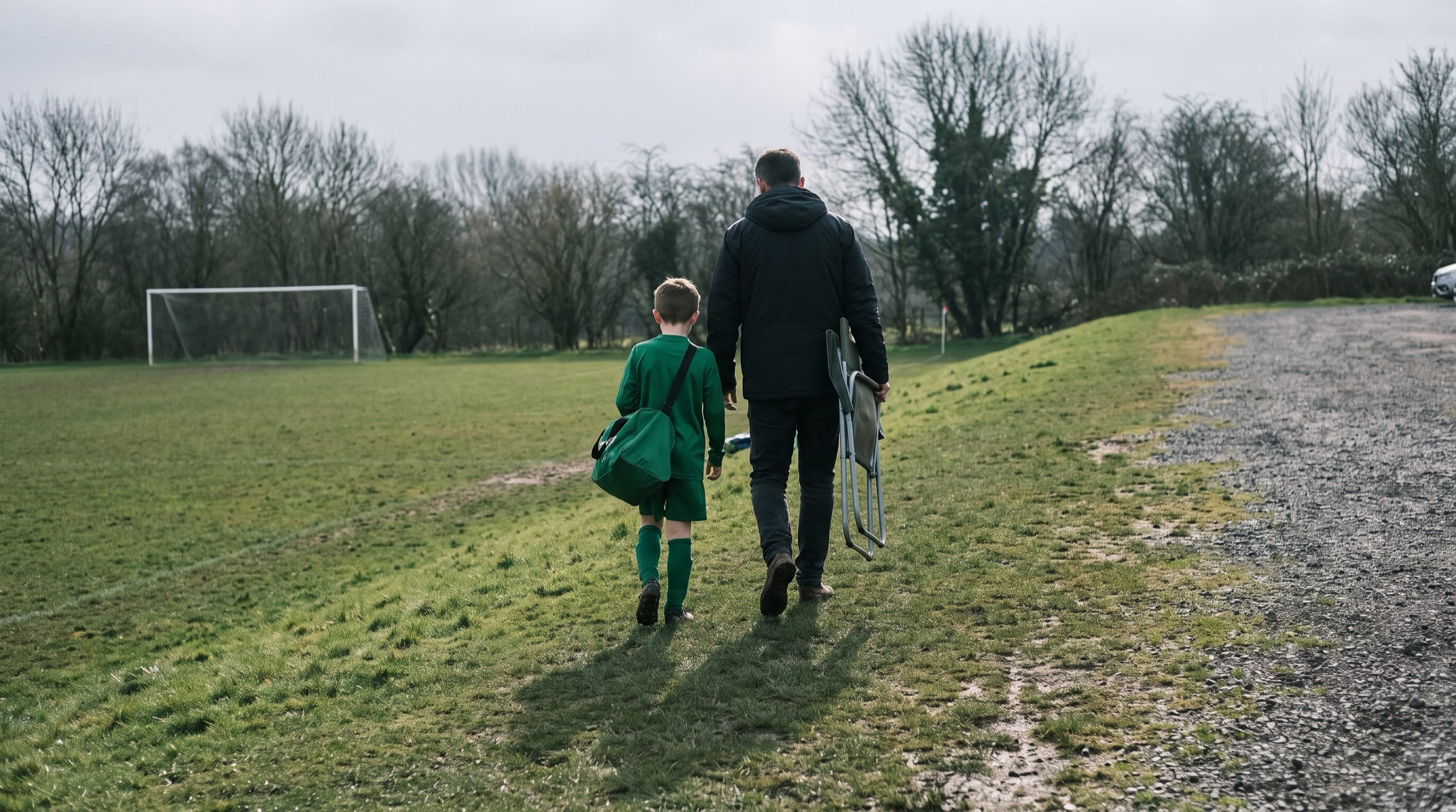 A parent and child walking off the pitch after a match, seen from behind. All people in Peer10 marketing imagery are synthetic.